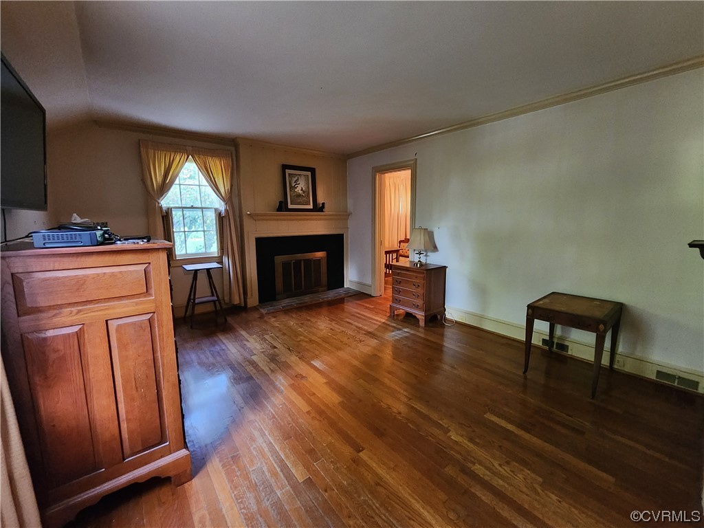185 Washington Street Boydton, VA 23917 - Photo 14 of 45 a living room with furniture a fireplace and a wooden floor