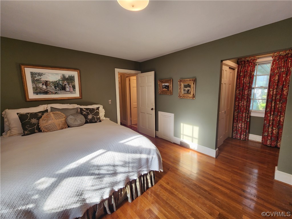 185 Washington Street Boydton, VA 23917 - Photo 24 of 45 a spacious bedroom with a bed and wooden floor