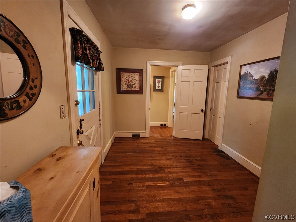 185 Washington Street Boydton, VA 23917 - Photo 26 of 45 a view of a bedroom with a large bed and a mirror