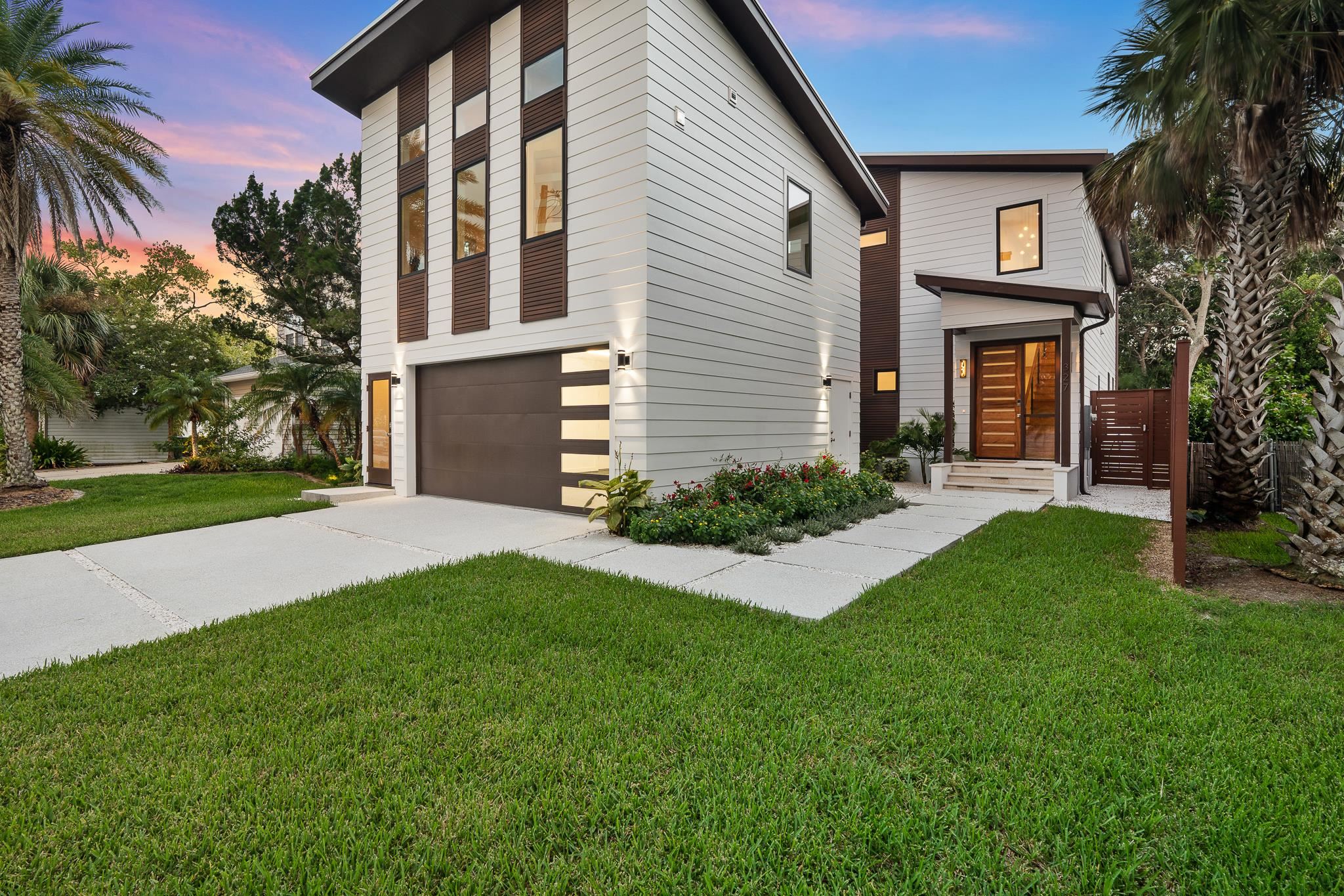 a front view of a house with a yard and garage