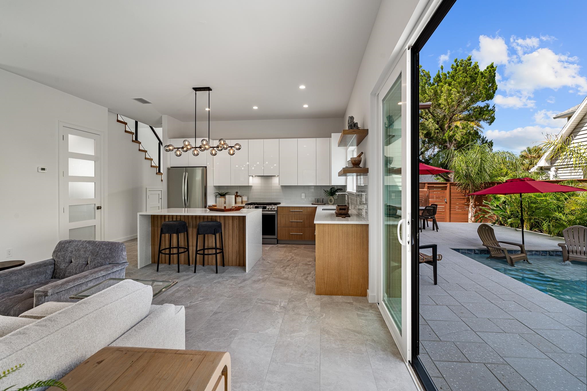 327 Minorca Avenue St. Augustine, FL 32080 - Photo 13 of 74 a open kitchen with stainless steel appliances kitchen island granite countertop a table and chairs in it