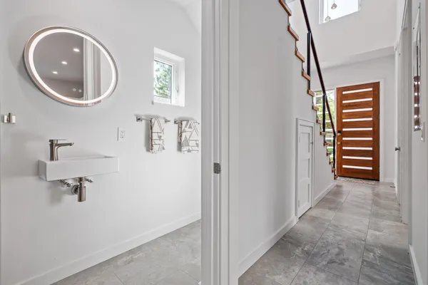 a bathroom with a double vanity sink toilet and shower