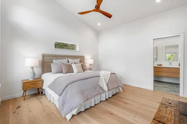 a bedroom with a bed and a night stand