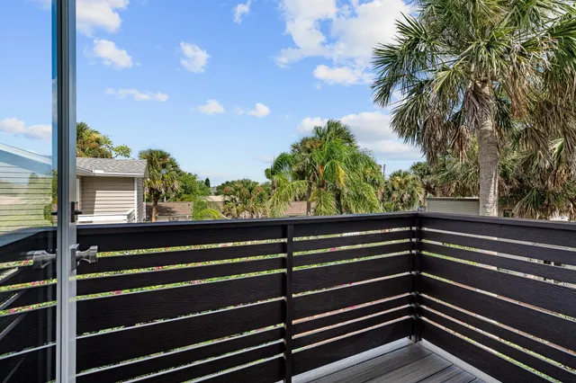 a view of a house with backyard sitting area and garden