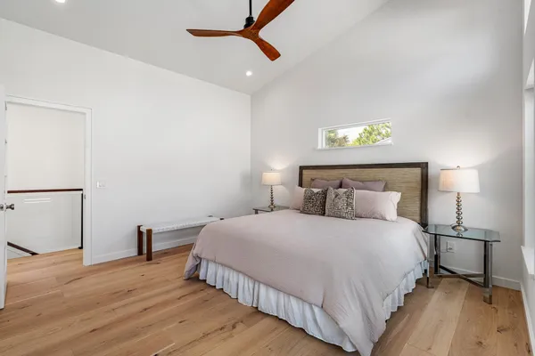 a kitchen with granite countertop a stove top oven a sink dishwasher a dining table and chairs with wooden floor