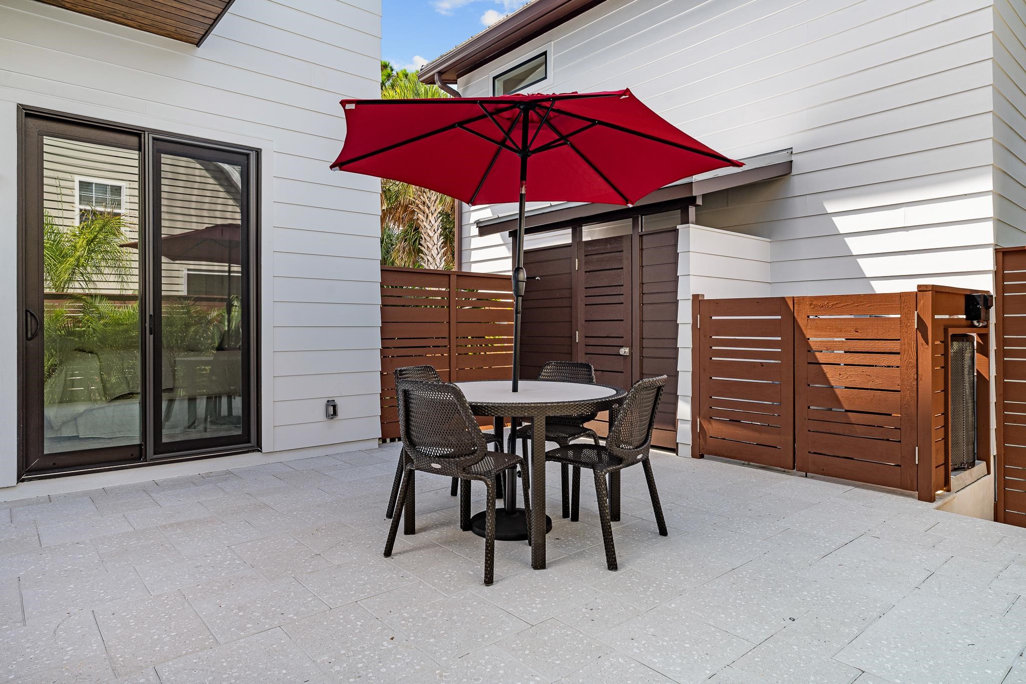 327 Minorca Avenue St. Augustine, FL 32080 - Photo 42 of 74 a view of a patio with table and chairs under an umbrella