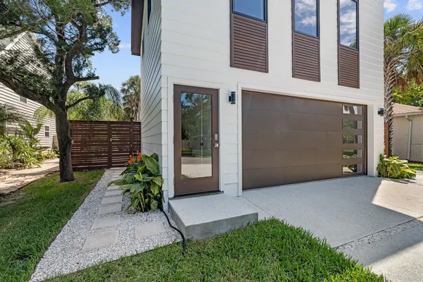 a view of a pathway of the house with a yard