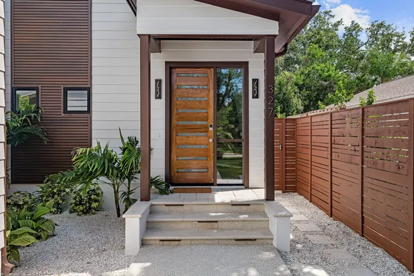 a view of a hallway with wooden floor and entryway