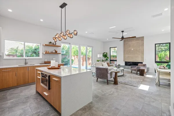a kitchen with a stove a sink and a window