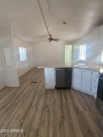 a view of a kitchen with wooden floor and a sink