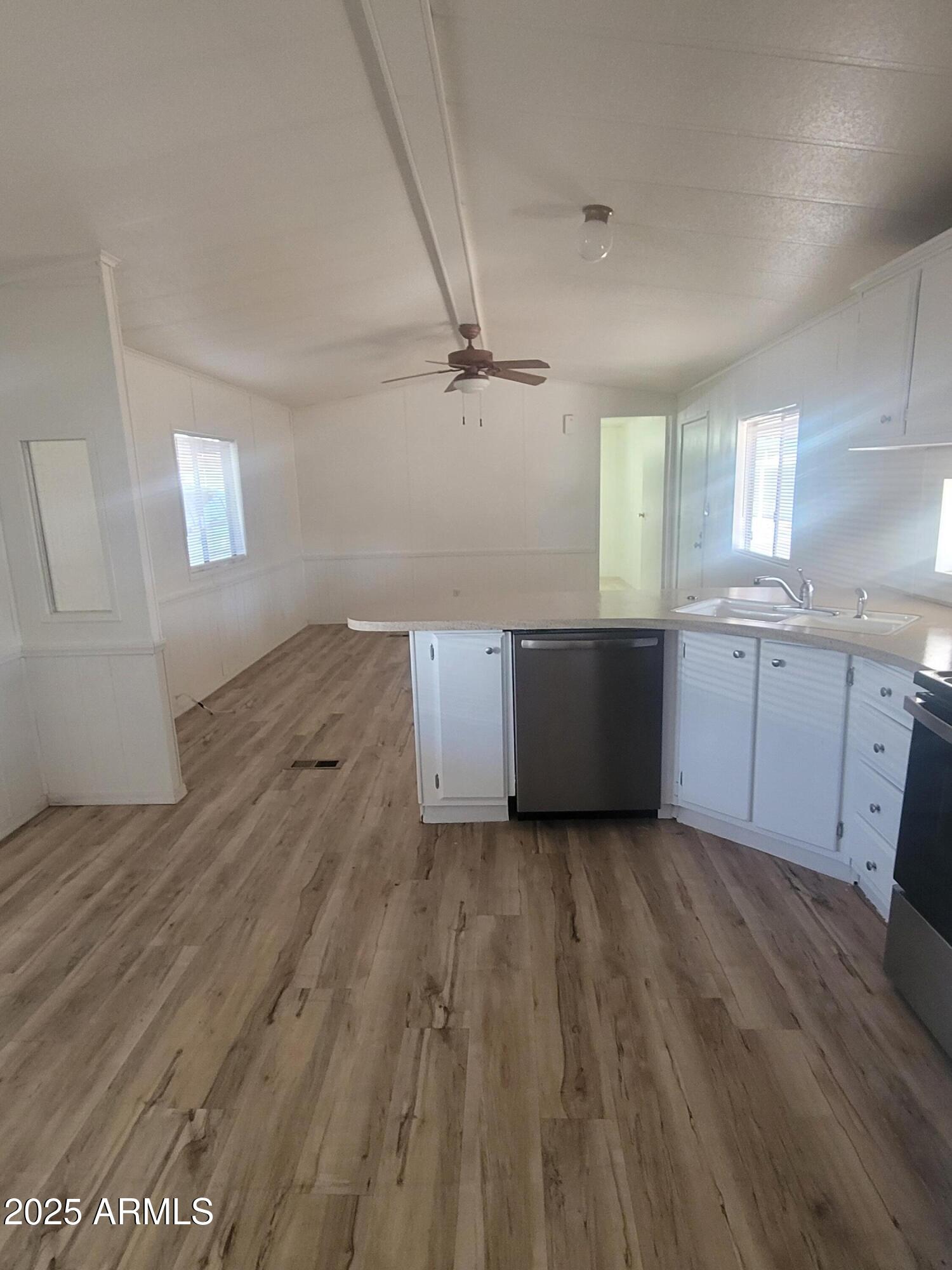 834 South Meridian Road, Unit 123 Apache Junction, AZ 85120 - Photo 1 of 26 a view of a kitchen with wooden floor and a sink