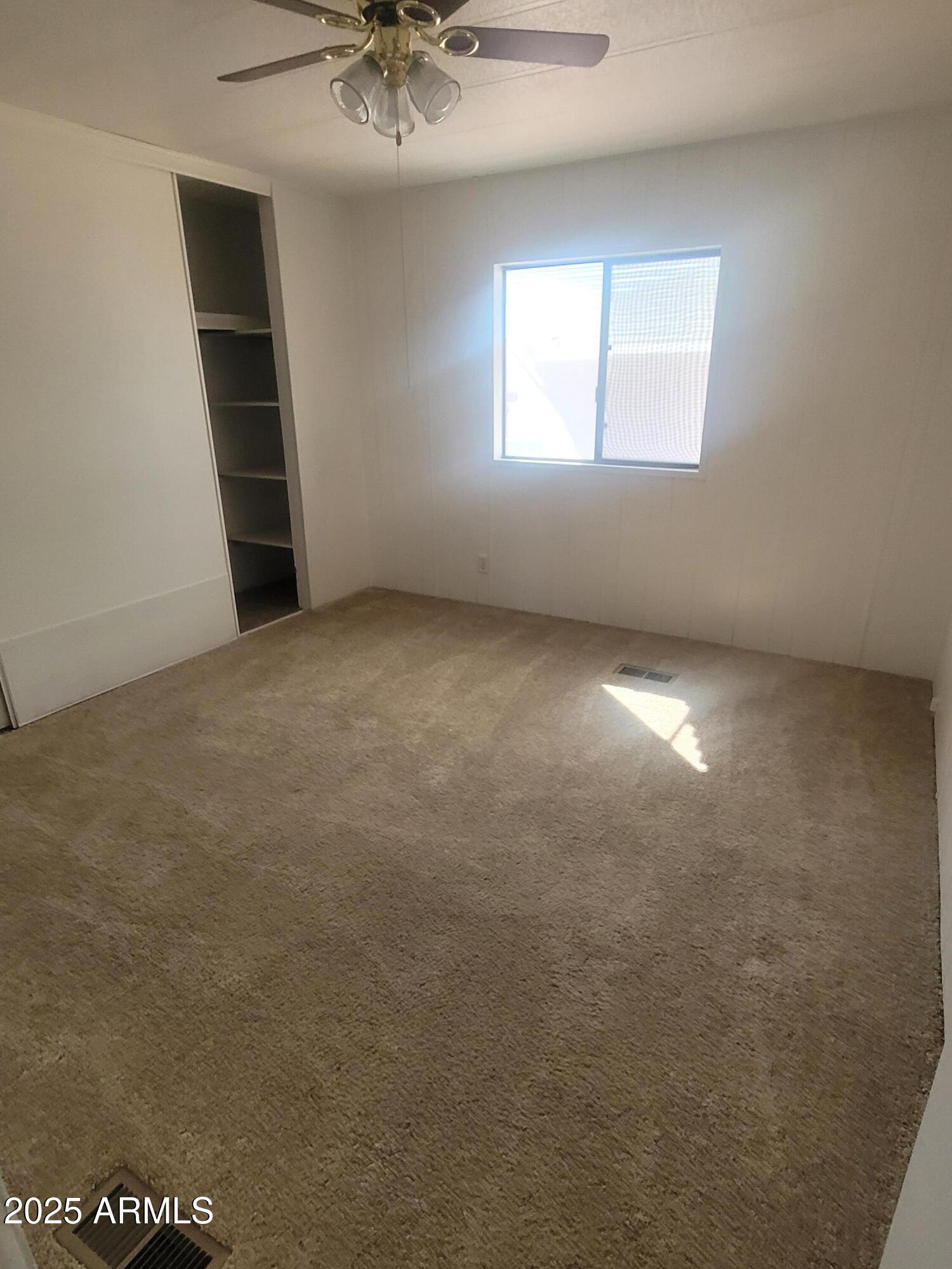 834 South Meridian Road, Unit 123 Apache Junction, AZ 85120 - Photo 11 of 26 an empty room with windows and closet