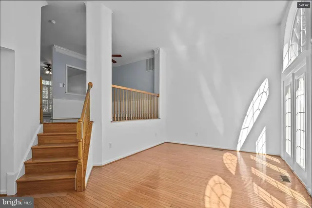 a view of entryway with wooden floor and stairs