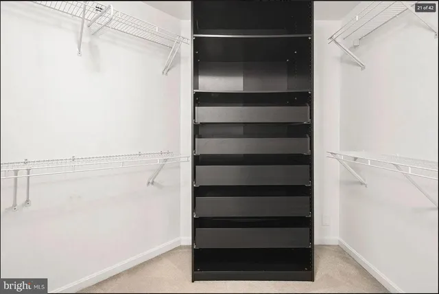 a view of walk in closet with empty racks