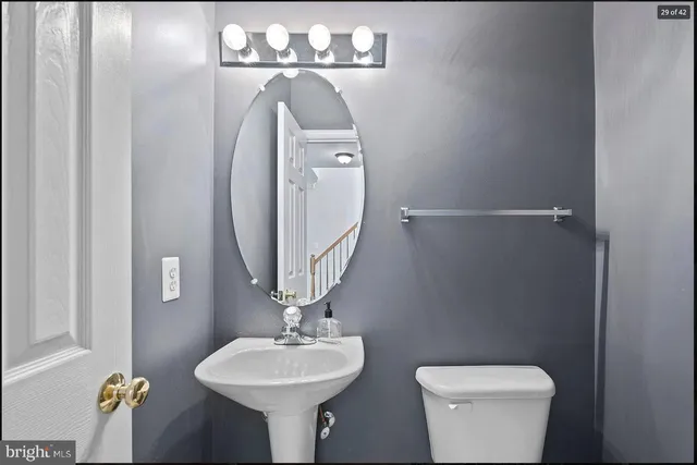 a bathroom with a toilet sink and mirror