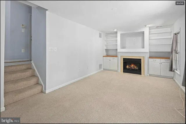 a view of empty room with a fireplace
