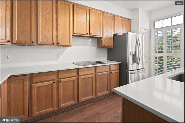 a kitchen with stainless steel appliances granite countertop a refrigerator a sink dishwasher with a stove and refrigerator