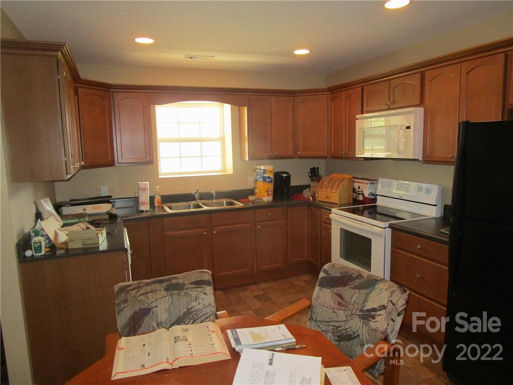 29 Aeronca Road Belton, SC 29627 - Photo 5 of 18 a kitchen with granite countertop a sink cabinets and stainless steel appliances