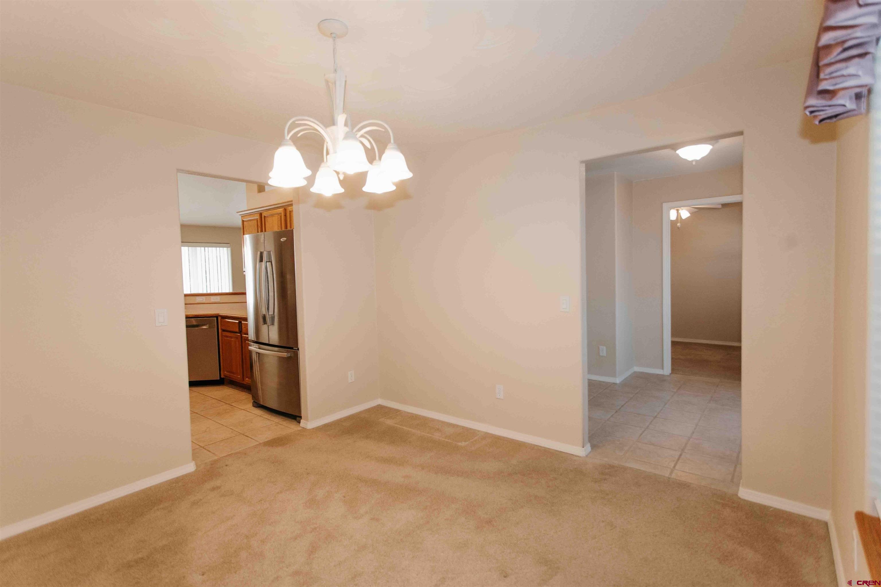 2806 Bluebell Court Montrose, CO 81401 - Photo 11 of 37 a view of a kitchen with a sink and refrigerator