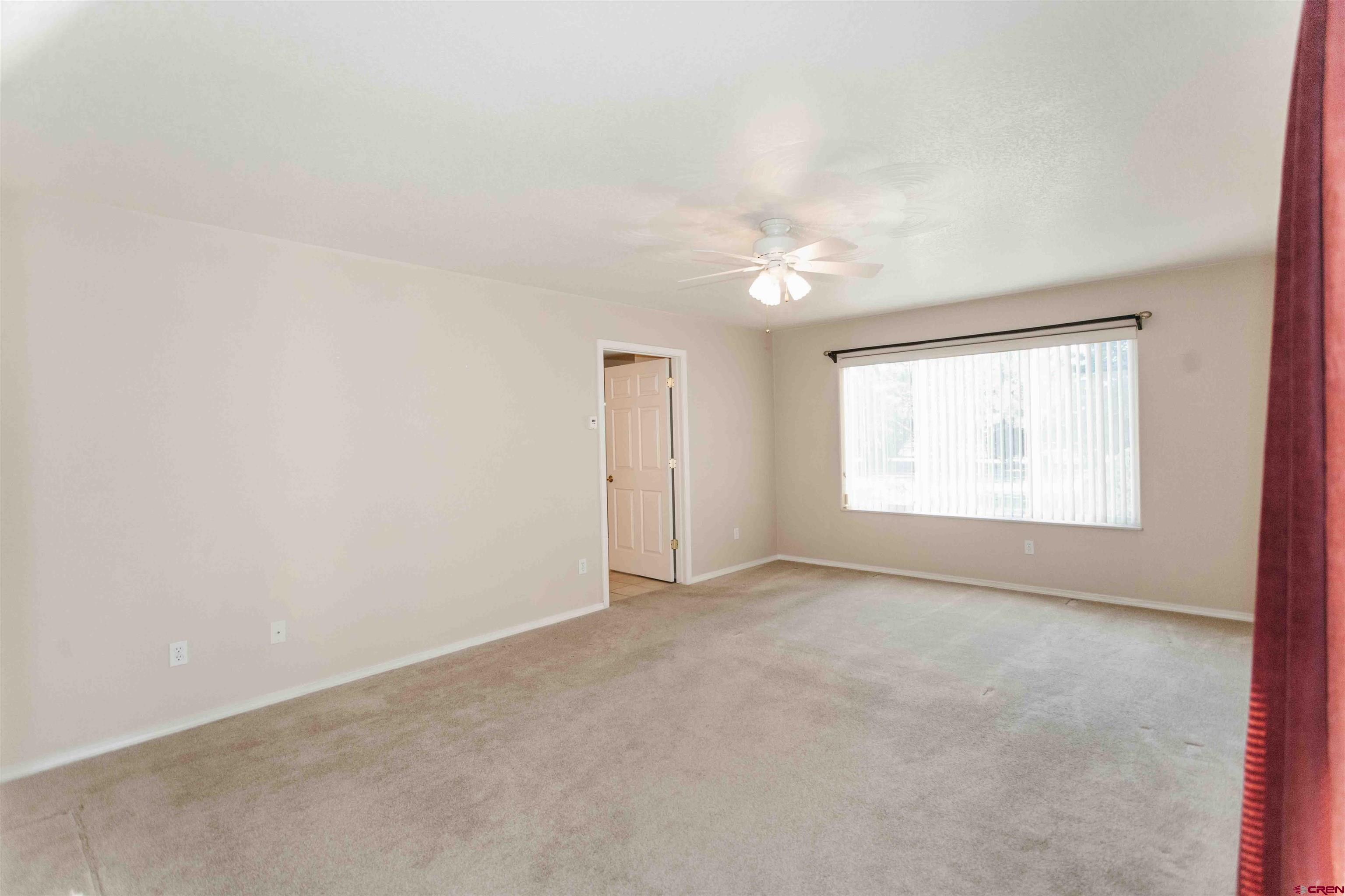 2806 Bluebell Court Montrose, CO 81401 - Photo 12 of 37 an empty room with windows and fan