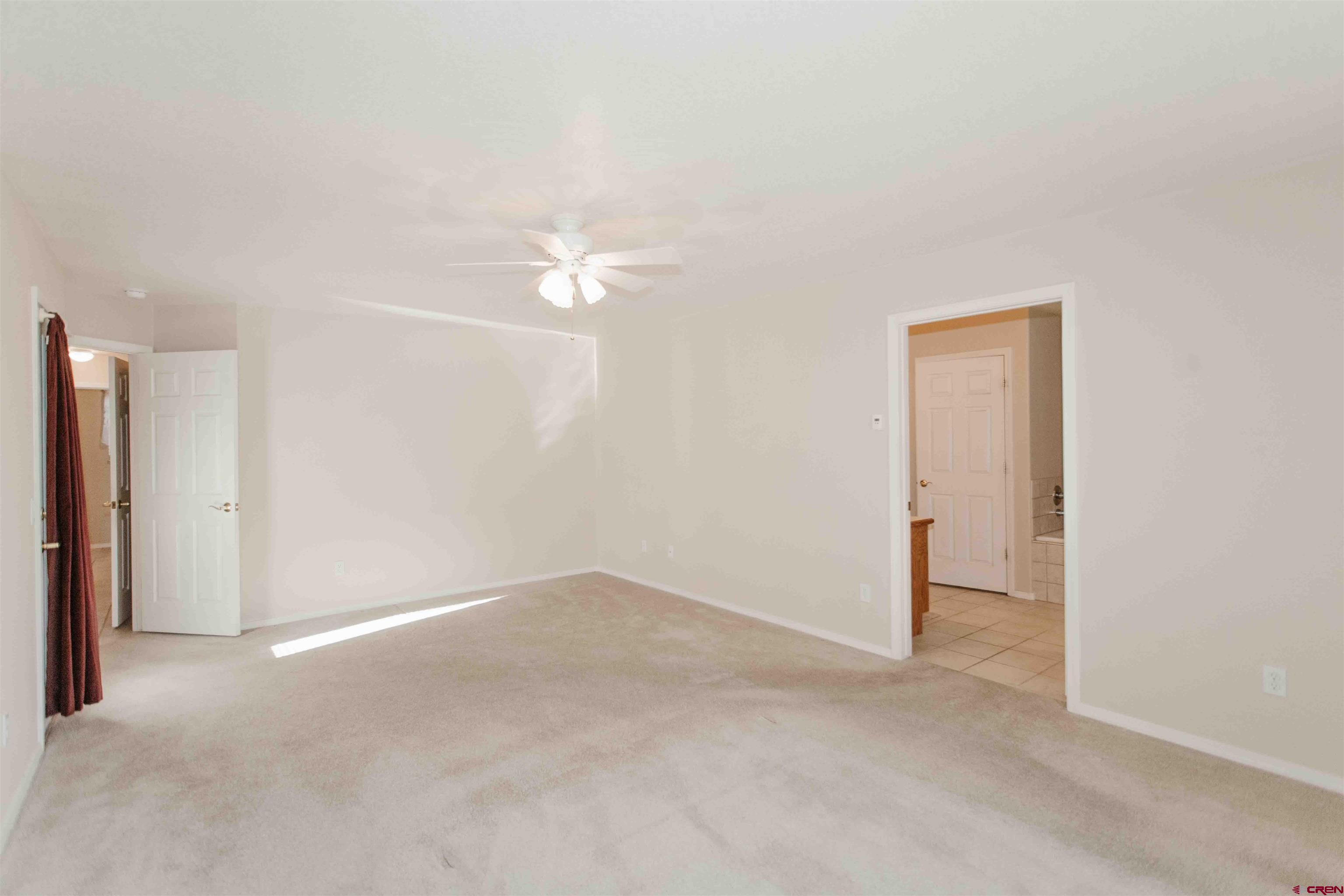 2806 Bluebell Court Montrose, CO 81401 - Photo 13 of 37 an empty room with a ceiling fan and a window