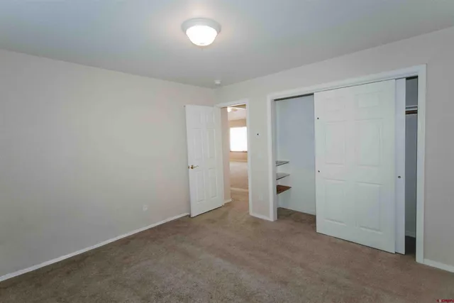 an empty room with an entrance to other room