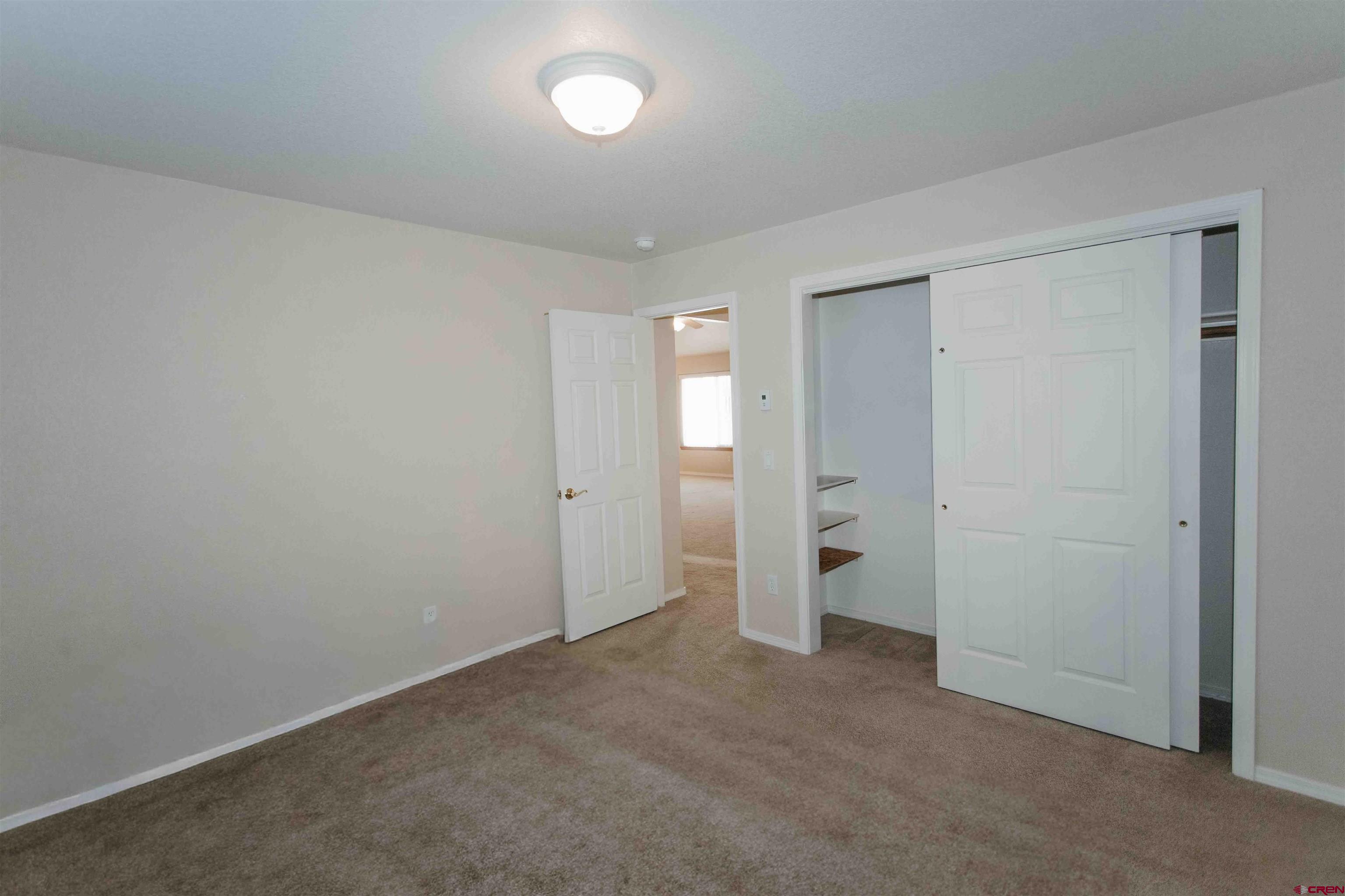 2806 Bluebell Court Montrose, CO 81401 - Photo 18 of 37 an empty room with an entrance to other room