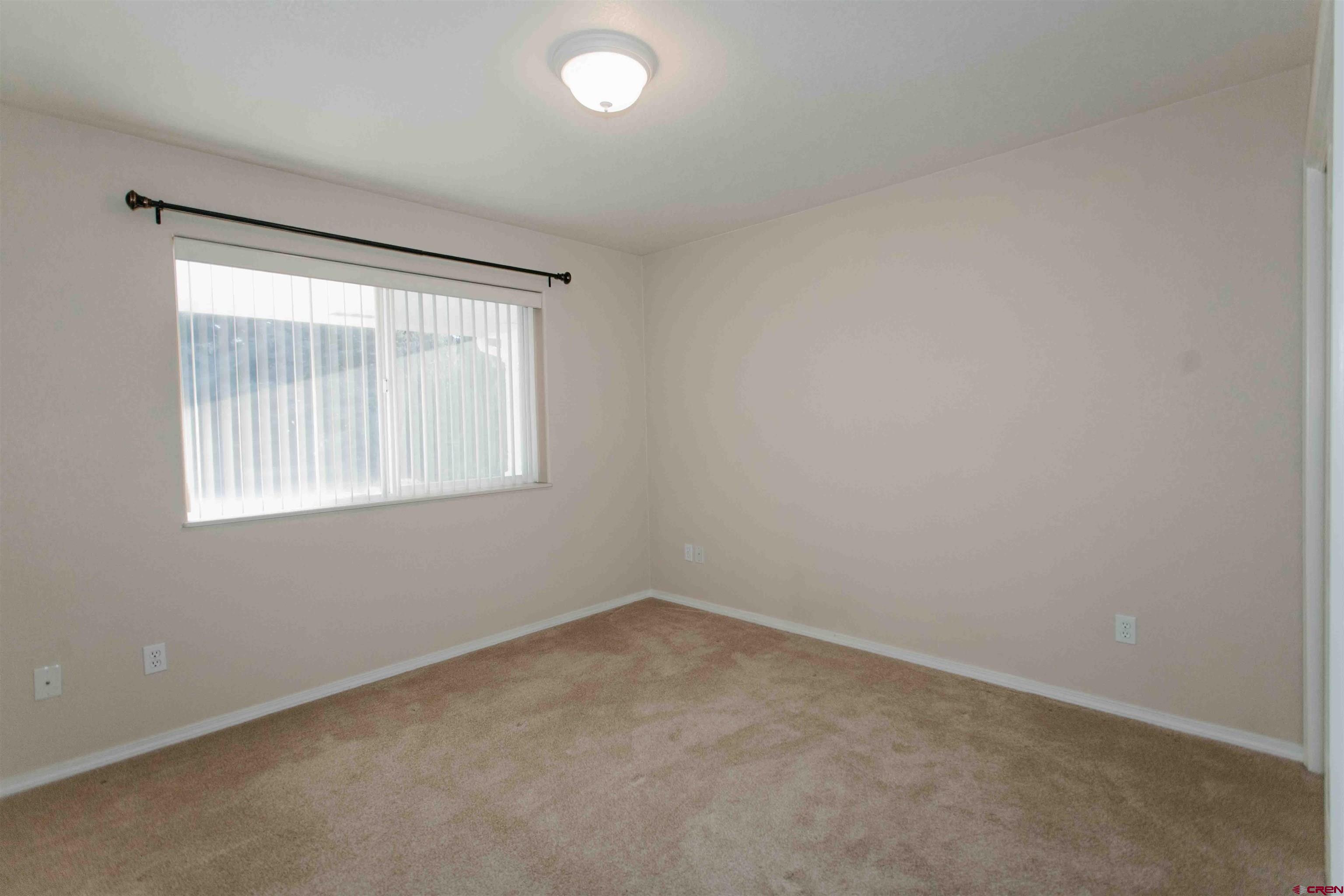 2806 Bluebell Court Montrose, CO 81401 - Photo 20 of 37 an empty room with a window