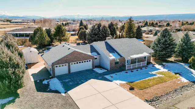 an aerial view of a house with a yard basket ball court and outdoor seating