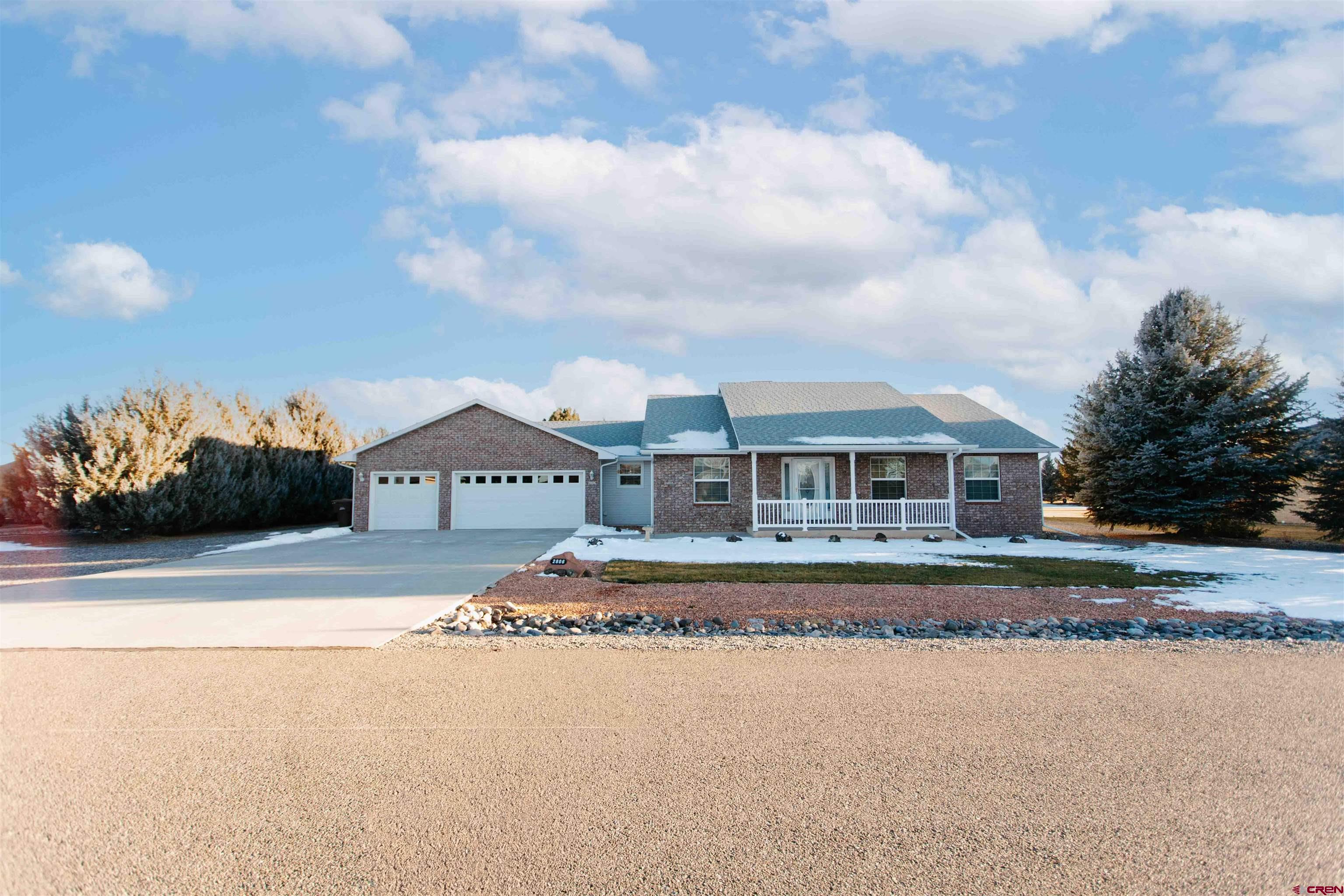 2806 Bluebell Court Montrose, CO 81401 - Photo 5 of 37 a front view of a house with a yard