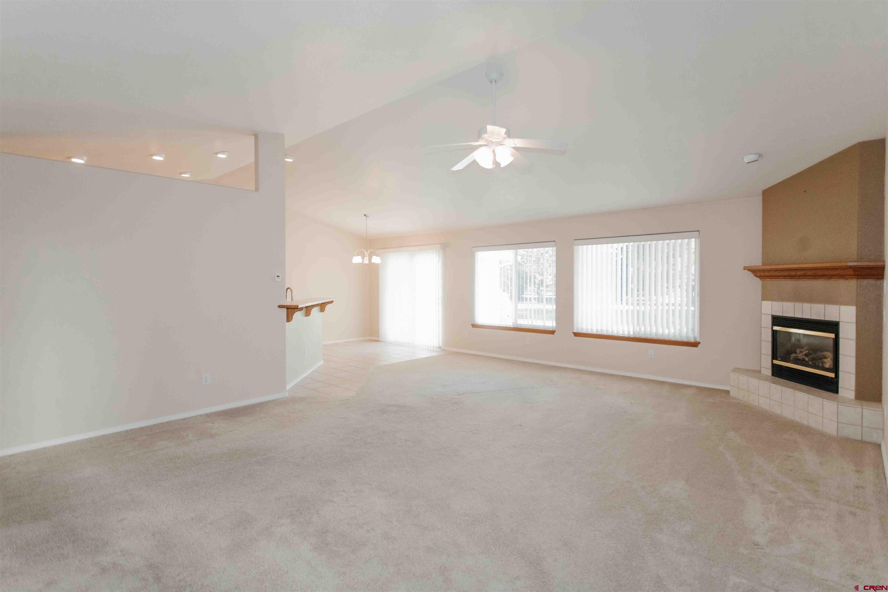 2806 Bluebell Court Montrose, CO 81401 - Photo 7 of 37 a view of an empty room with a window and a fireplace