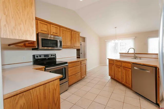 a kitchen with stainless steel appliances a stove sink microwave and cabinets