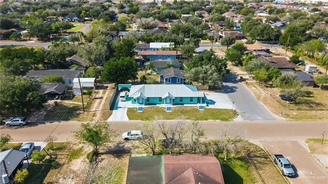 an aerial view of residential houses with outdoor space and swimming pool