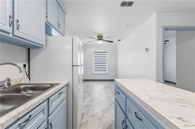 a kitchen with a sink cabinets and appliances