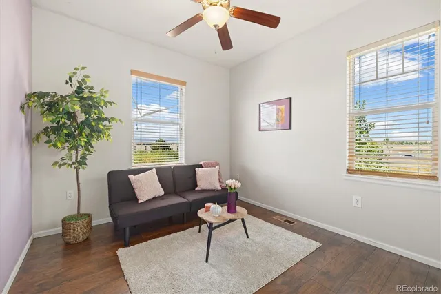 a living room with furniture and a potted plant