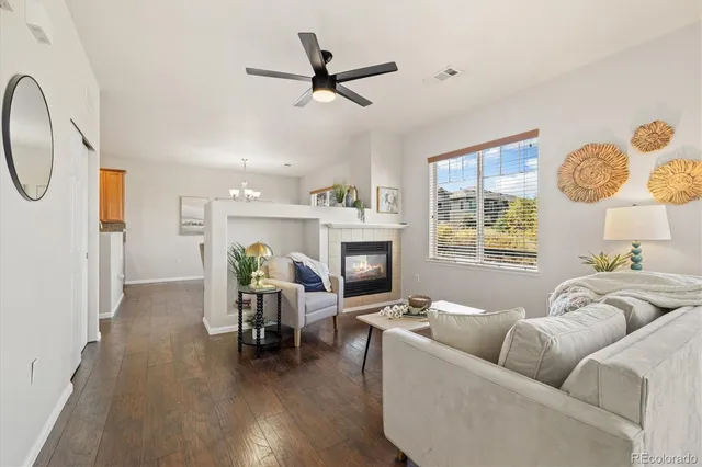 a living room with furniture a fireplace and a window