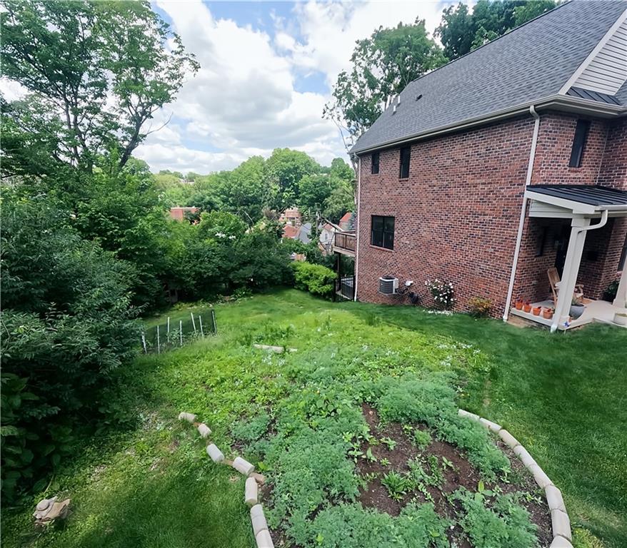 318 Garland Street Pittsburgh, PA 15218 - Photo 2 of 8 a view of a backyard with potted plants and large tree