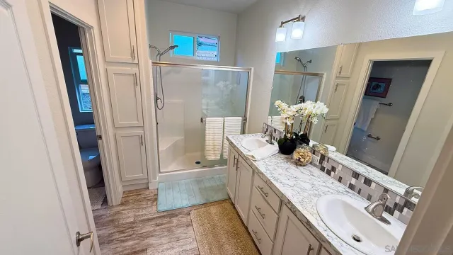 a bedroom with a bed and a mirror