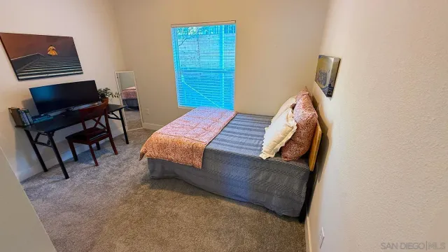 a bedroom with a bed and a table in it