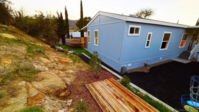 a view of house with backyard