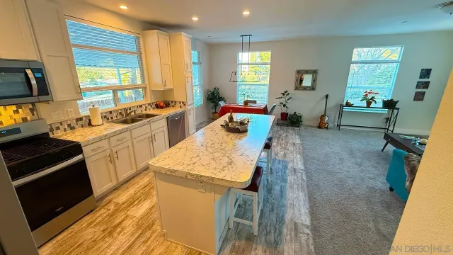 a kitchen with sink refrigerator and window