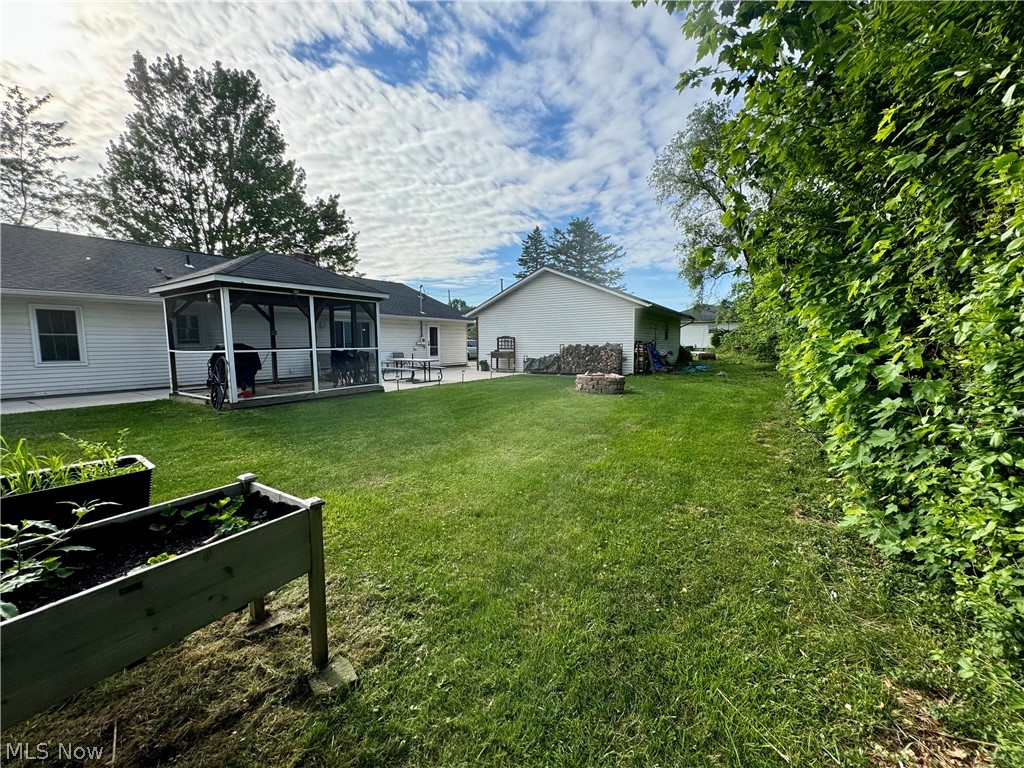 7199 Murray Ridge Road Elyria, OH 44035 - Photo 27 of 29 View of yard with a sunroom and a patio area