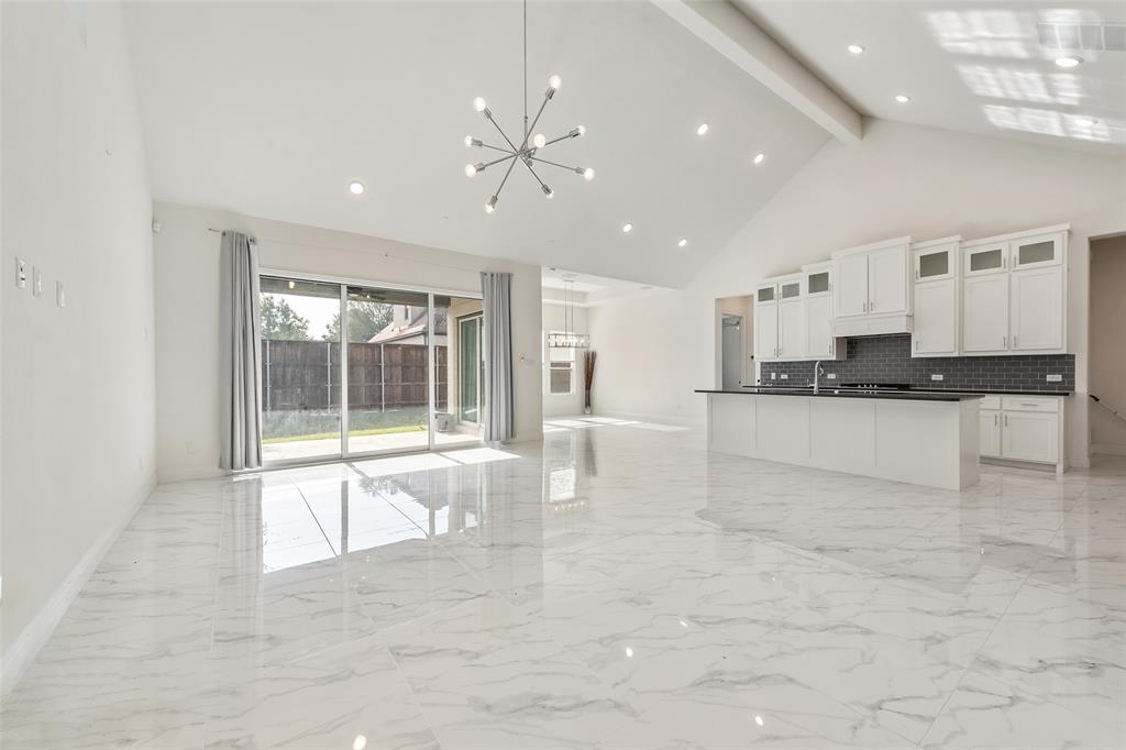 2714 Chambray Lane Mansfield, TX 76063 - Photo 12 of 32 a large white kitchen with granite countertop a stove a sink a refrigerator and white cabinets with wooden floor