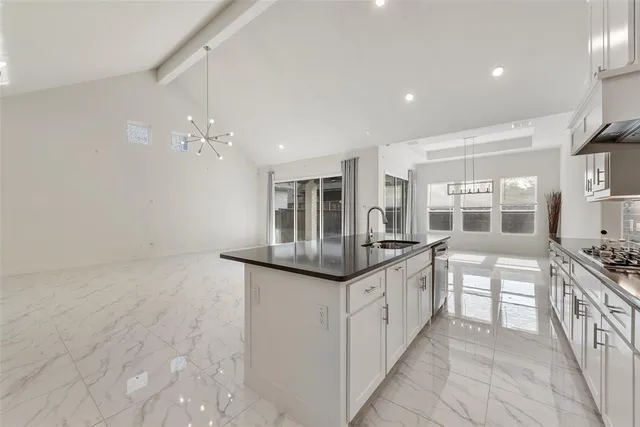 a kitchen with stainless steel appliances granite countertop a sink and cabinets