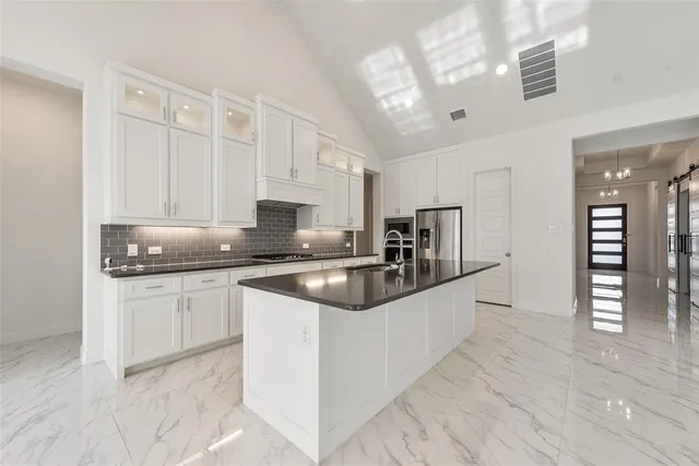 a kitchen with granite countertop a sink and cabinets