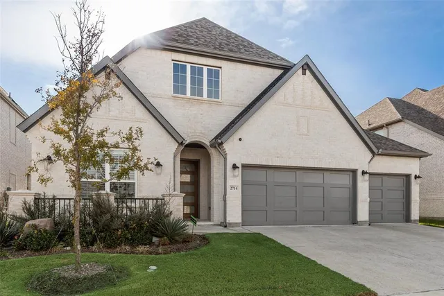 a front view of a house with a garden and plants