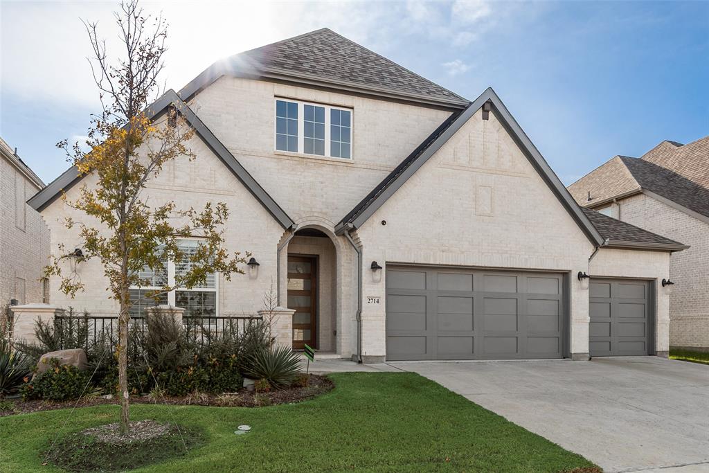 2714 Chambray Lane Mansfield, TX 76063 - Photo 2 of 32 a front view of a house with a garden and plants