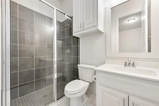 a bathroom with a sink toilet and shower