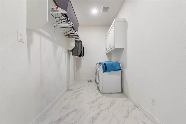 a view of storage and utility room with washer and dryer