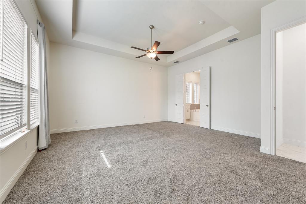 2714 Chambray Lane Mansfield, TX 76063 - Photo 24 of 32 an empty room with chandelier fan and windows